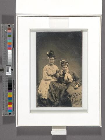 Portrait of two unidentified women in hats and fancy dresses