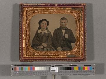 Unidentified young man and woman sitting side-by-side