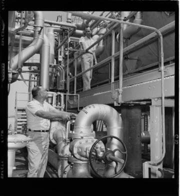 Man having his eyes examined; Men working at a steam plant or a water desalination plant