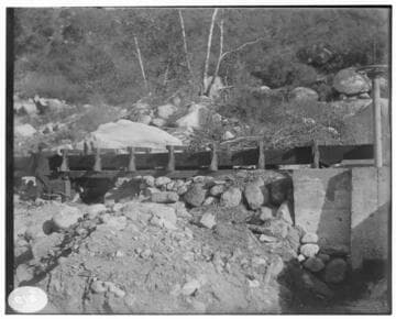 An unknown flume line showing rock formations above and below