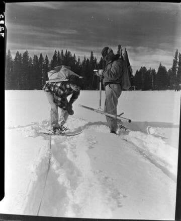 Big Creek snow survey.  Close up of men reading depth and weight of snow in snow