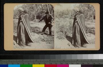 Hualapai Indian woman drinking water from a pottery jar while a man stands nearby