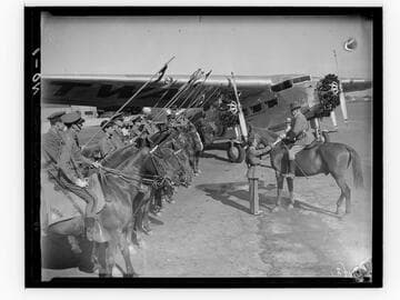 Students from Urban Military Academy on horses lined up next to TWA airplane, Los Angeles, California