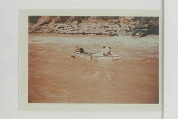 Dropping down the eddy below Vulcan Rapid after lining the Nevills sadirons.  Nevills scrambles to close the hatch.  Joe Desloge and Margaret Marston sit on the stern