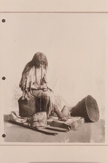 The woman, in dress acquired by the Powell Expedition and surrounded with specimens from the same Expedition