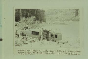 On the left bank at the lower end of Lava Falls.  Kolb and Blake are wearing the dangerous choke-bored breeches.  Boatmen are Leigh B. Lint, Emery Kolb, and [Henry] Elwyn Blake, reading left to right.  Repairing boat.  Grand Canyon at Lava Falls