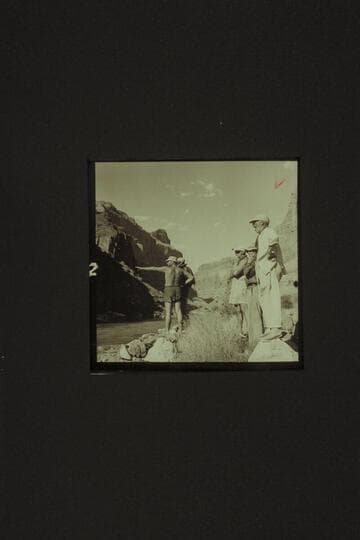 Belknap outlines his selected path through Lava Falls to Rod Sanderson at left.  Masland sees the "Rocks, Rocks."  Taylor wonders if it is a riffle and Marston appears bored but he isn't.  Lava Falls from the left bank