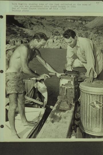Norm Nevills showing some of the junk collected at the camp of the men who parachuted into Grand Canyon in 1944.  End of Grand Canyon traverse of 1948, July