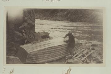 The Kolb brothers repairing the "Edith" on Christmas day after Emery wrecked her by running too close to the right shore in Waltenberg Rapid