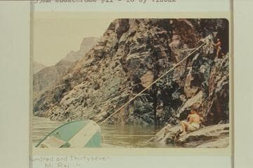 Salvage work on wrecked inboard-outboard at head of Gneiss Canyon Rapid.  John Harrington below and Homer Morgan above