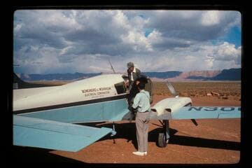 MGM is helped from plane by John Hamilton; Cliff Dwellers Lodge