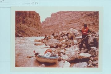 Dock Marston lining a Sportyak thru Dark Canyon Rapid.  Jorgen Visbak and Buzz Belknap in distance