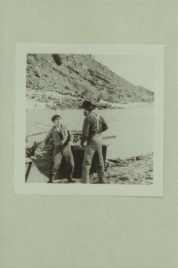 Walter Powell (played by Jim Drury) prepares to swing on Major Powell (played by John Beal).  Actionin the Disney filming of "The Colorado River Story."  Colorado River near Castle Creek above Moab