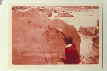 Dock Marston running water onto the Best Expedition inscription near the river at Mile 204 1/2 right bank