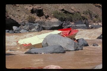 "Wee Red" on rocks; Vulcan Rapids