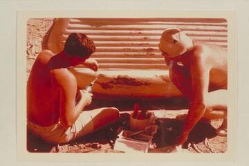 Bill Belknap watches Buzz repair the Sportyak.  Camp at Mile 209.6.  Right bank between Rapids #6 and #7