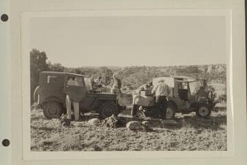 Kent Frost's jeeps en route to the Needles country.  Joe Desloge stands with hands in pockets in background.  Kent Frost arranges luggage at right.  Masland has back to camera at right
