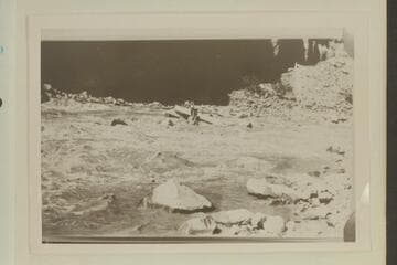 Salvage of rock-locked boat in Dark Canyon Rapid.  USGS Cataract Canyon survey under W. R. Chenoweth.  Copy of small print owned by Chenoweth.  LaRue album No. 177.  Print in Tasker album