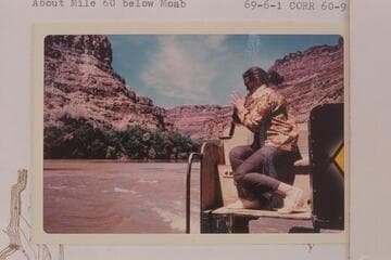Virginia Hough at some close photography as she sits on the bow of the "Bert Loper."  About Mile 60 below Moab