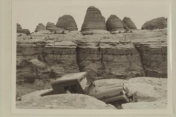 Kent Frost driving his jeep up heavy grade in Needles Country.  Margaret Marston rides as passenger.  Elephant Creek enters the Colorado at Mile 3.1