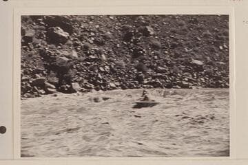 Boat dropping off far right tongue of Hance Rapid.  At this stage there is a midstream course as well as one just to left of the run made by the boat in the photo