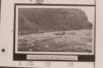 USGS boat in Rapid No. 21 which heads at Mile 202.8 and drops 10 ft. in 0.25 miles.  Mouth of Teapot Canyon.  Print No. 107 in LaRue album in Huntington Library