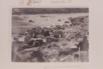 Bill Belknap and Dock move down to camp at Mile 202.25.  The Rapid is #23 or The Buzzter, which heads at Mile 202.20 and drops 9 ft. in .15 miles