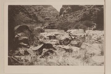 The motorboat "City of Moab" tied to the bank of the Grand River above the Junction after failing to make passage up the rapid at the Slide