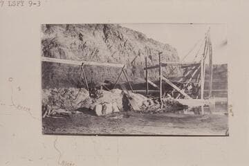 Lovett pneumatic pipe dredge suspended at outer end of flume preparatory to operation