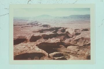 Down the Escalante River to Stevens Creek at the left, Stevens Arch at center, Coyote Gulch at right, Fifty Mile Mountain at upper right and Navajo Mountain upper