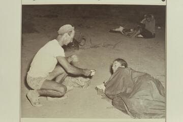 Norm Nevills serves coffee to Anne Desloge for the benefit of Bureau of Reclamation photographer William S. Russell.  End of 1947 Traverse of Grand Canyon at Pierces Ferry