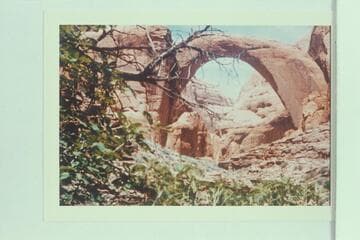 Inscription:  "The Worlds Greatest Natural Bridge, 309 ft. high, 277 ft. span, Discovered and Surveyed Aug. 14, 1909" on rock at foot of Rainbow Bridge
