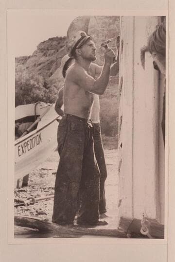 Buzz Holmstrom helping with the repair of one of the Nevills skiffs at Pats Hole.  Note the short hold on the hammer