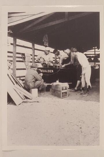 Conditioning the boats at Lees Ferry.  Lint album.  Completing repairs on the "Boulder."  In semi circle left to right:  Lint, Blake, Freeman, Kolb