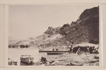 The heavy boats of the Eddy Expedition being overhauled at Lees Ferry.  The "Powell" shows at left.  The "Coronado" is center and the "Dellenbaugh" is on the beach.  Copied from Carey collection