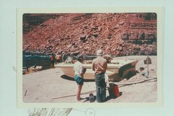 The crippled I-O [inboard-outboard] on the beach at low water at mouth of 22 Mile Wash