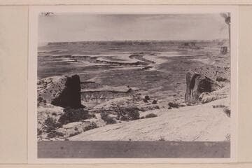 View southwest from Upheaval Dome--white rim sandstone edges the wide red Moenkopi bench.  The Buttes of the Cross are upper right.  Bonita Bend is center