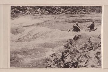 Canoe entering Grave Creek Falls in traverse of Rogue River by six UC students in 1954.  "The canvas deck allows the high, curling waves to sweep across without swamping the canoe."