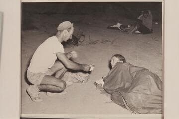 Norm Nevills serves coffee to Anne Desloge for the benefit of Bureau of Reclamation photographer William S. Russell.  End of 1947 Traverse of Grand Canyon at Pierces Ferry