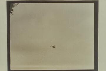 Above Badger Creek Rapid.  Georgie White at the oars and Elgin Pierce in the 10-man neoprene inflated boat in which they traversed the Marble and Grand Canyons in July 1952