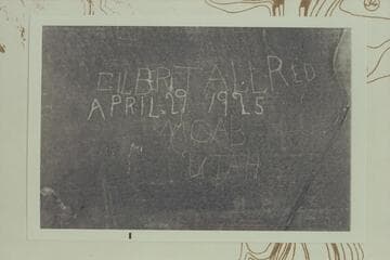 Inscription at lower end of Beaver Bottom in cave of White Rim Formation