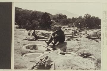 Pools in the slickrock in Bisha Canyon.  Navajo Mt. in background