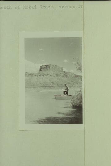 Nevills studying the river charts.  Will have to look up the name of this butte.  I believe it is near Nokai Canyon or the Balanced Rock [John E. Galley]  Near mouth of Nokai Creek, across from No Mans Mesa