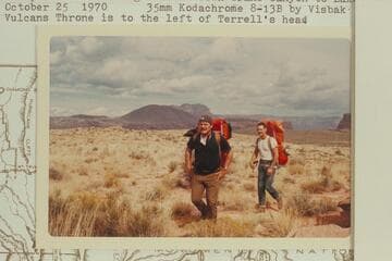 Mac Terrell and Bill Mooz hiking down Prospect Valley to the rim prior to starting a float down Grand Canyon to Lake Mead.  Vulcan's Throne is to the left of Terrell's head