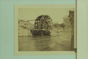 Water wheel below railroad bridge at Green River, Utah