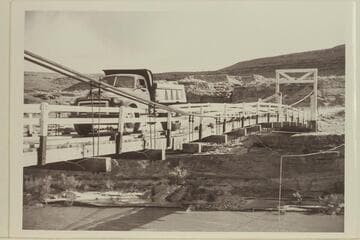 A truckload of uranium ore crossing the bridge at Mexican Hat.  The obvious strain on the structure broke it and the bridge was replaced