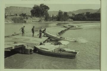 The empty boats of the USGS survey party being let over the dam above Green River, Utah