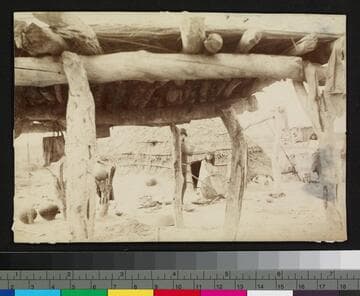 A man speaking to a woman outside a hogan