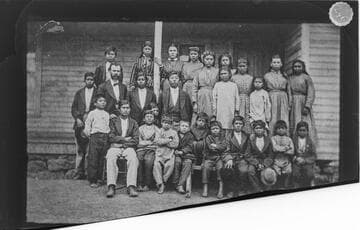 Modoc school children, girls and boys, with their white teacher, ca. 1875