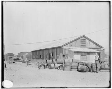 A man standing in front of the Machine Shop at Los Angeles #3 Steam Plant